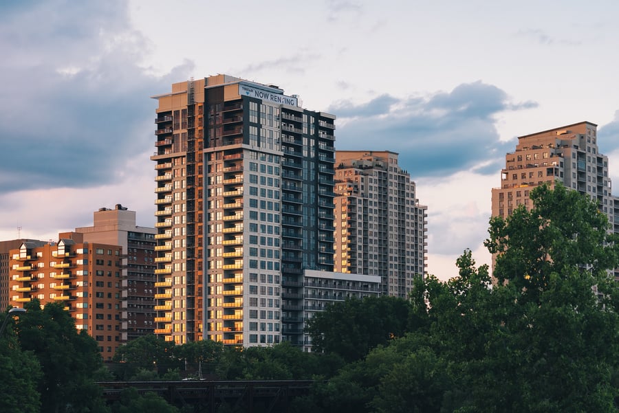 Modern Apartment Buildings Among Trees at Sunset